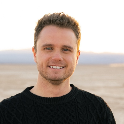 Braden Tomlinson, Founder of Sagebrush Staging. Wearing a black sweater with a desert landscape in the background, Las Vegas/Henderson, Nevada. Real Estate Specialist.